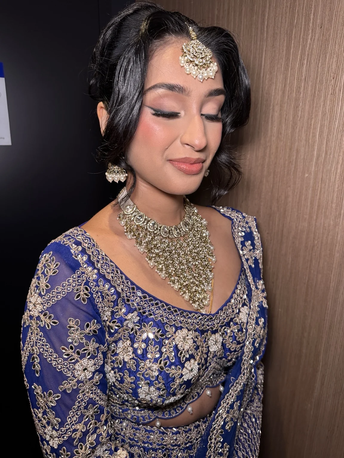 Avishma’s blue reception look, with coordinated bridal hair and makeup by Heera