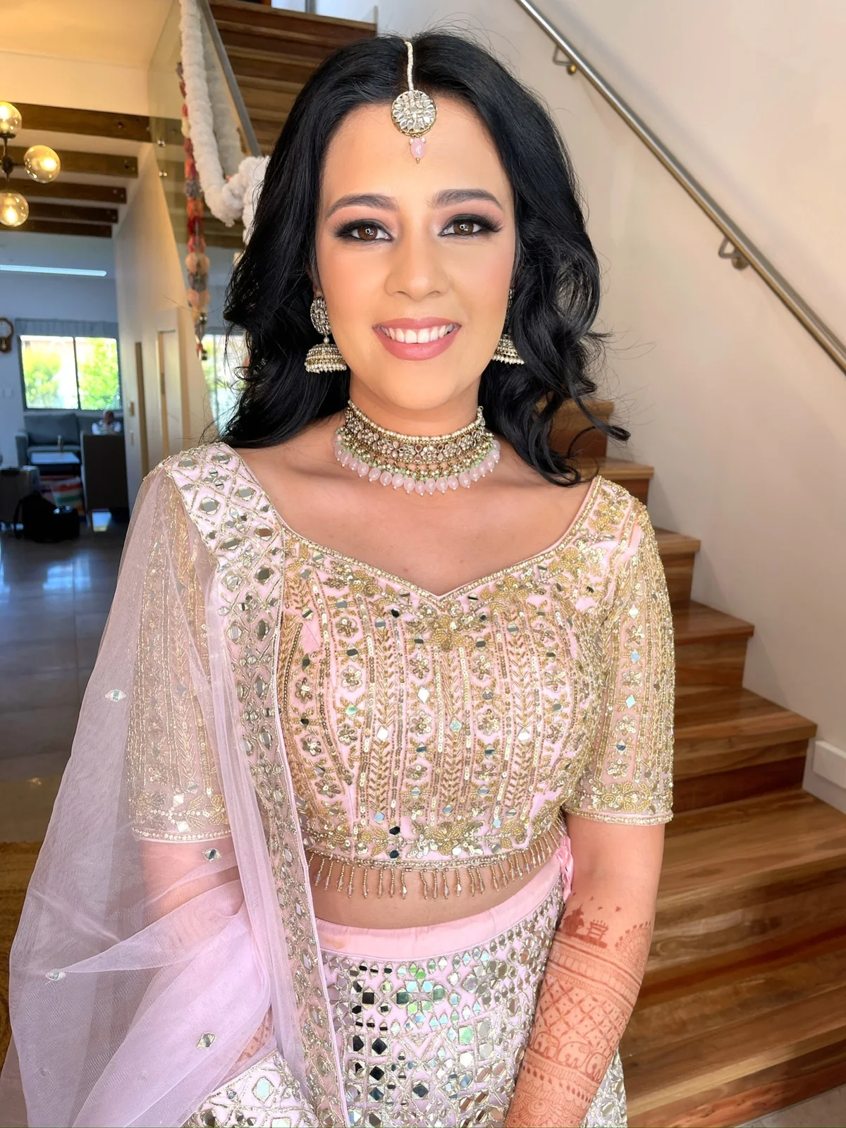 Embellished blush outfit, lavender draping, softly waved hair and luminous makeup