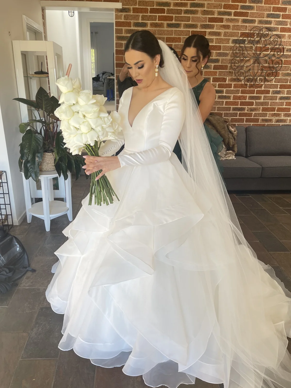 A flowing white gown, bridal bouquet and softly styled hair