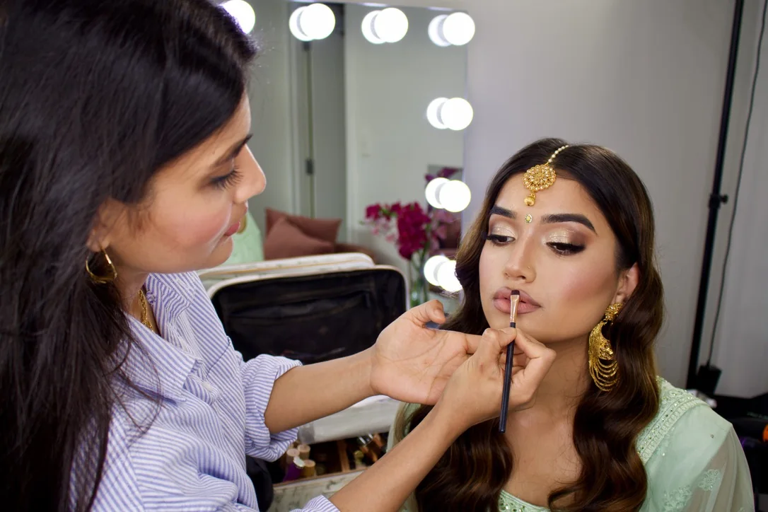 Heera refining a client’s lip colour in the studio