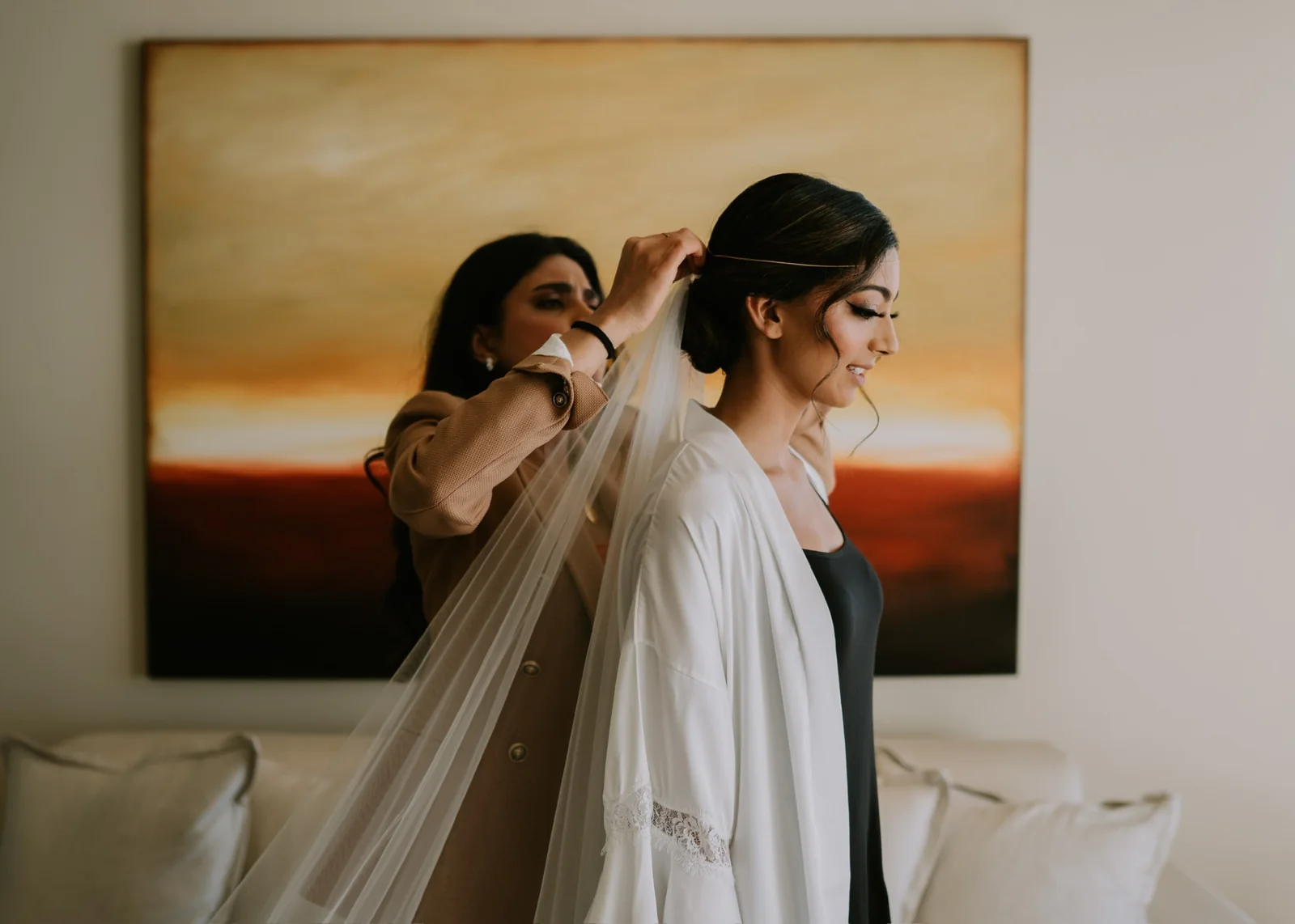 Heera placing a veil into a bride’s updo