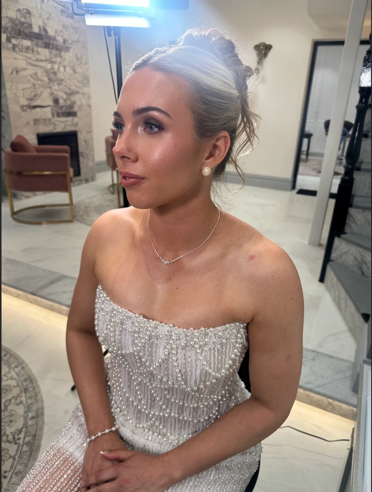 Jess with softly defined bridal makeup and a textured blonde updo at Heera’s Sydney studio