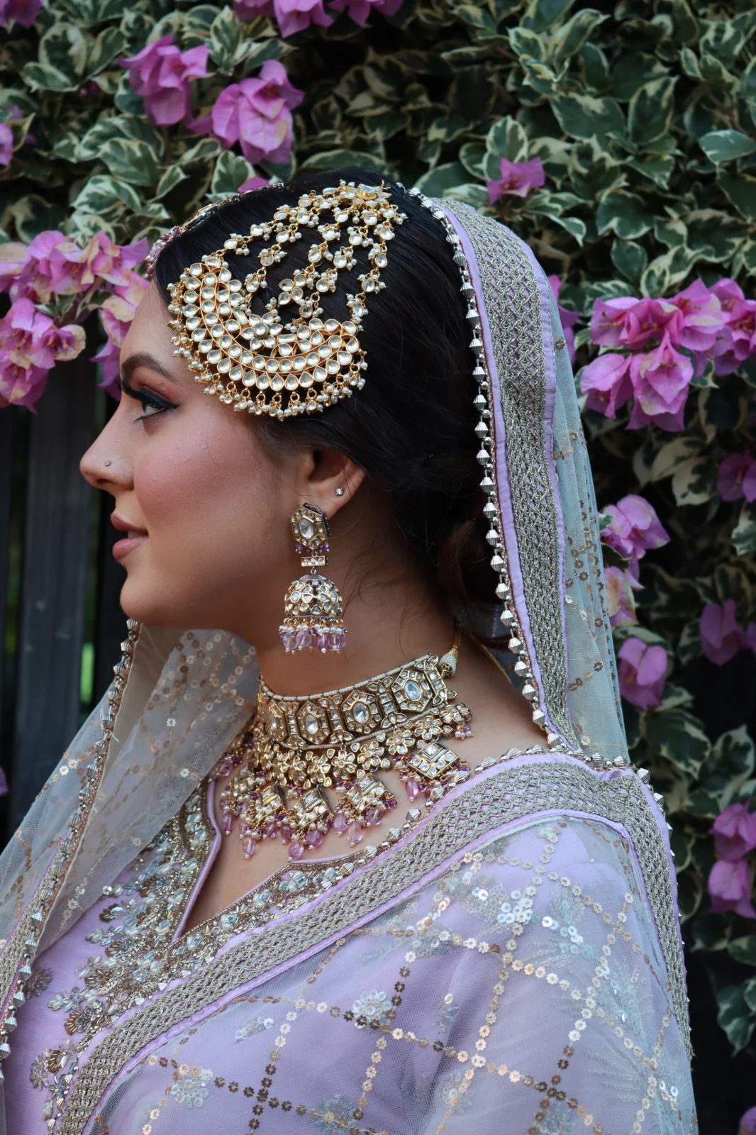 Lavender bridal styling by Heera with defined eyes, softly swept hair and gold hair jewellery