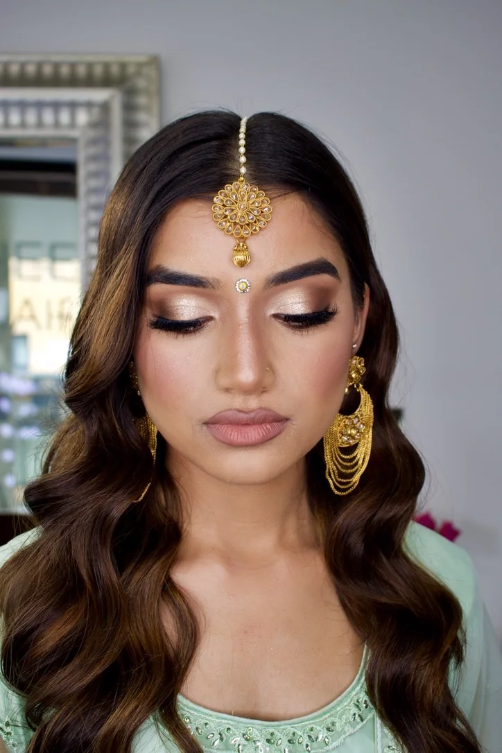 Close-up of shimmering bridal eye definition, softly sculpted colour and polished waves
