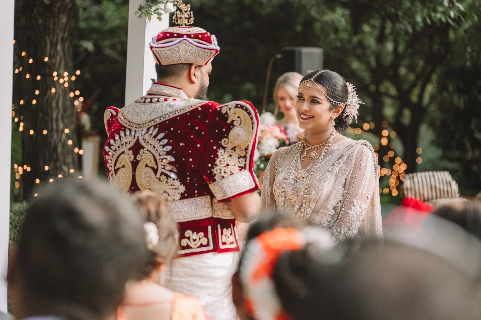 A bride with a coordinated bridal look by Heera sharing a joyful ceremony moment