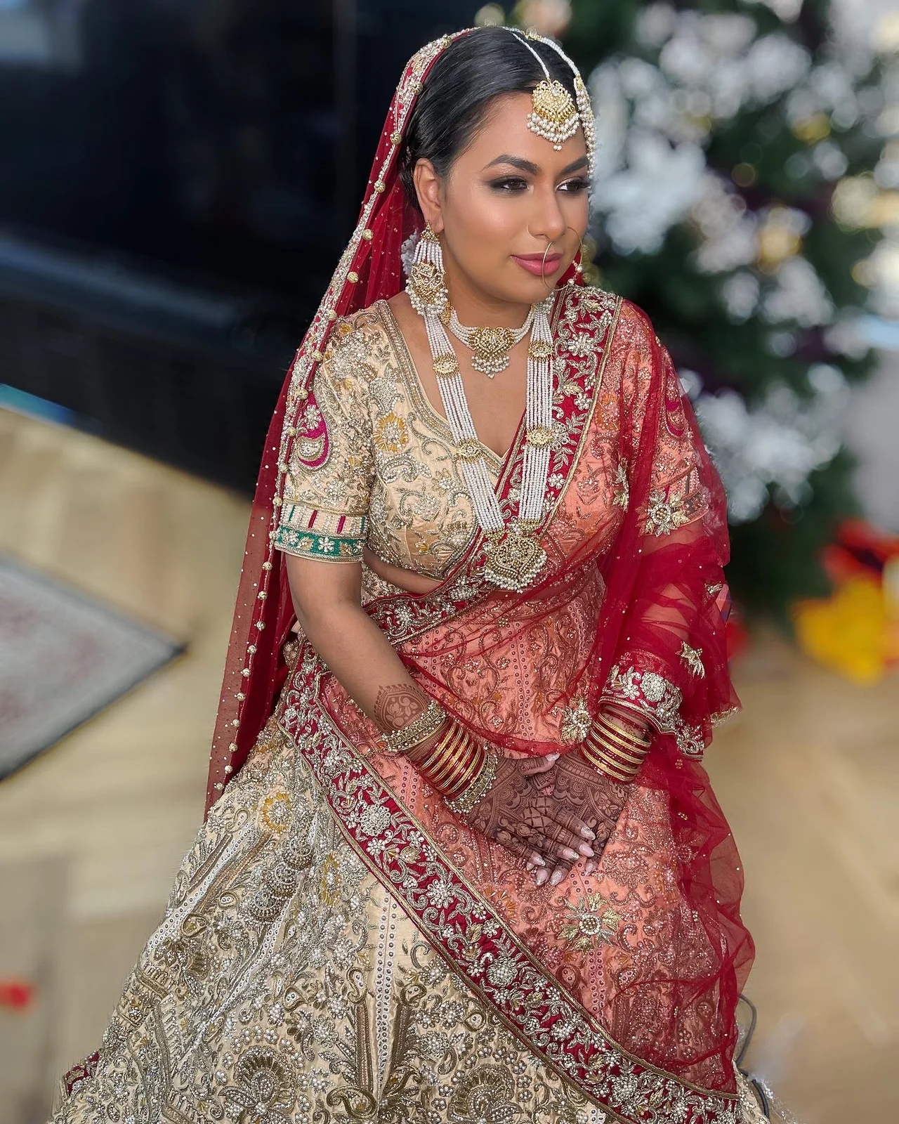 A red dupatta, detailed jewellery and softly framed hair