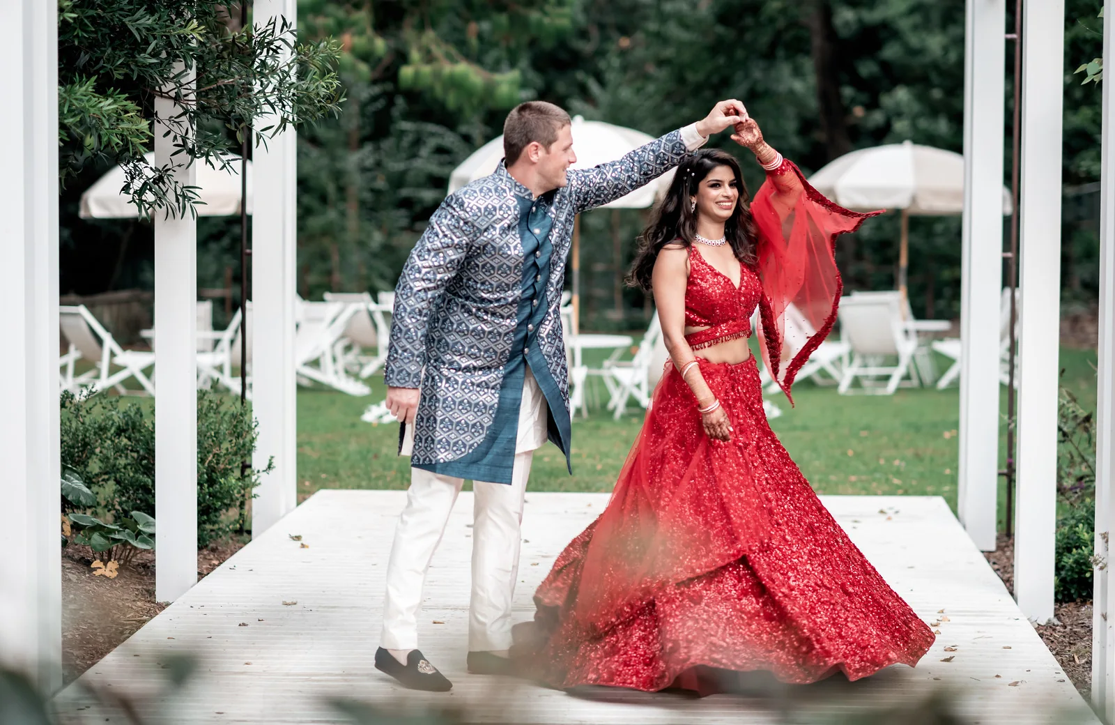 Shiv twirling in a red dress during her Jamberoo Lodge wedding celebrations, with hair and makeup by Heera