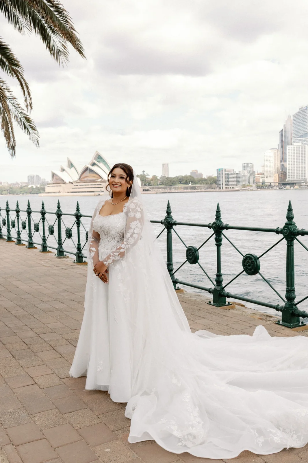 Sydney Harbour bride with soft waves, a veil and a white lace wedding gown