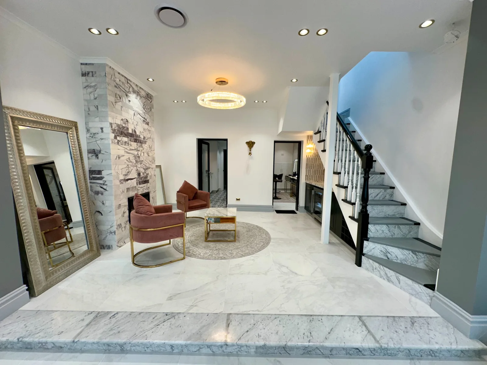 Heera’s Ultimo bridal studio with blush lounge chairs, a gold-framed mirror and marble finishes