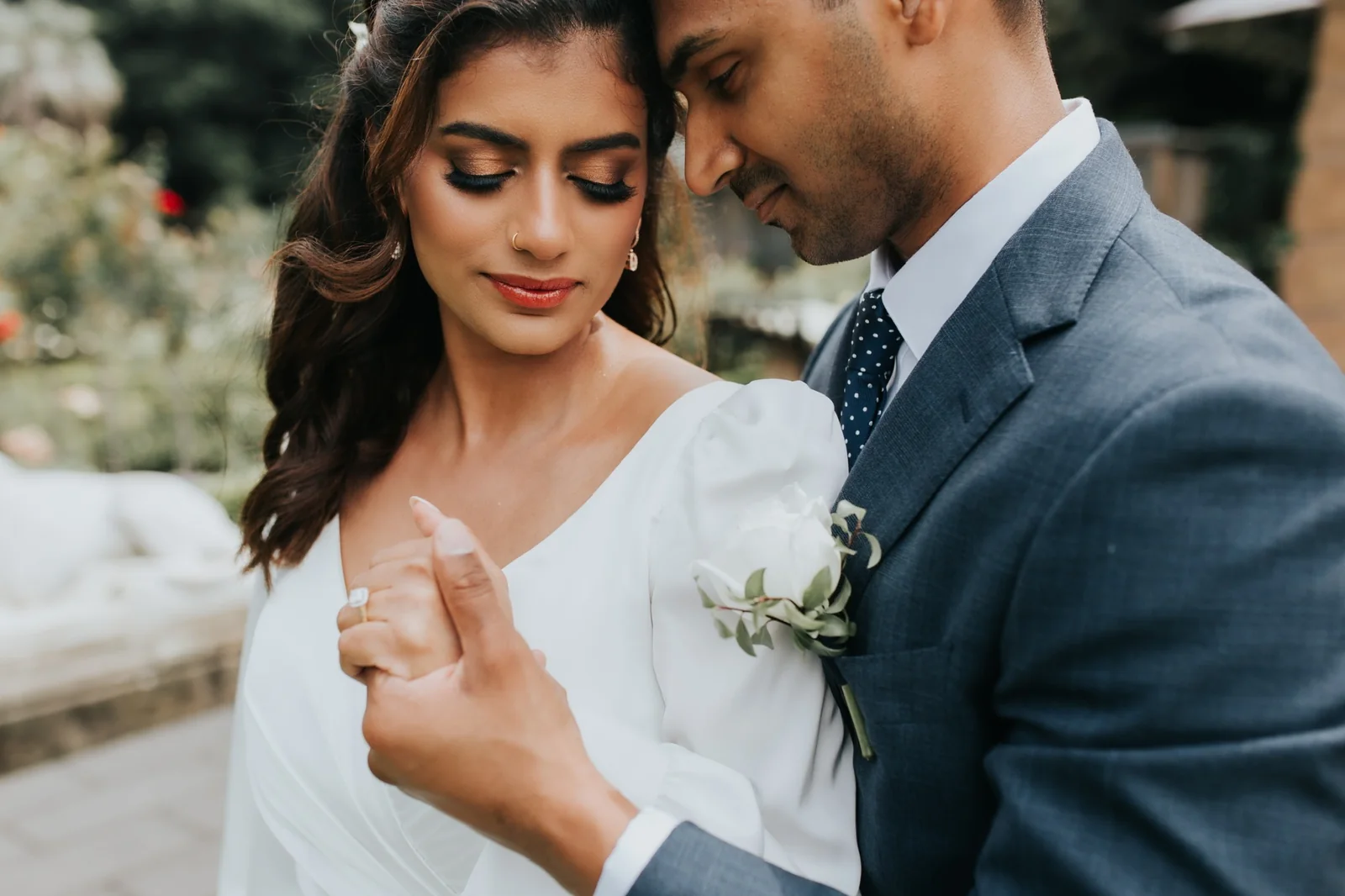 White-gown bride with softly framed hair beside her partner